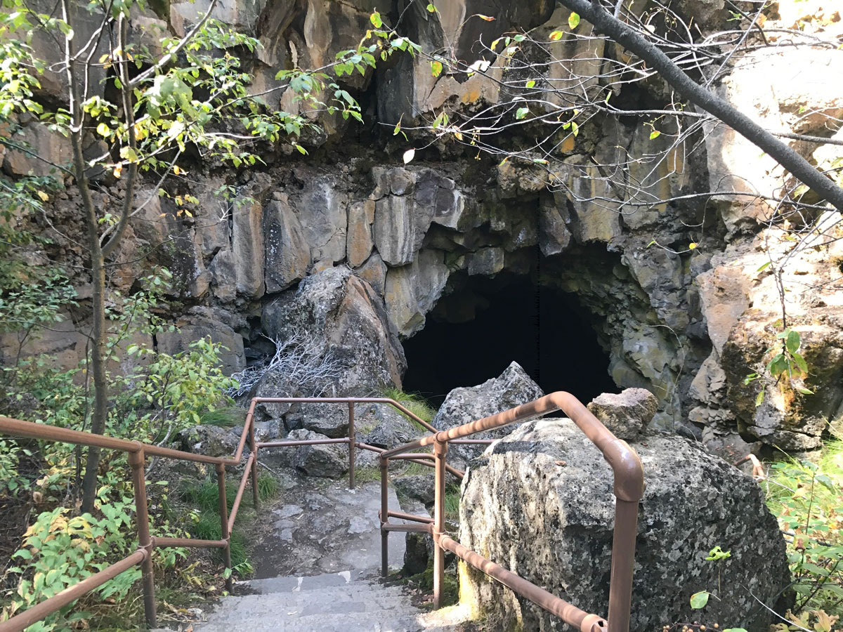 Dark cave tunnel with light at the end