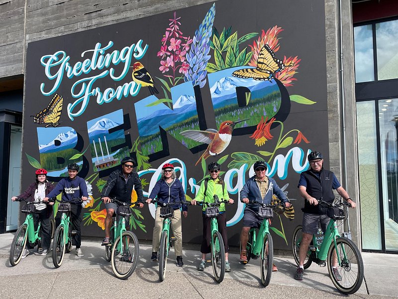 Riders on e-bikes following a river path